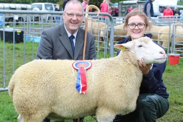 Georgina Mulligan holds the Ile de France Champion, exhibited by 
Edward Adamson, at Ballymena Show 2019. She was joined by the judge of this year's Ile de France classes Trevor Boyd