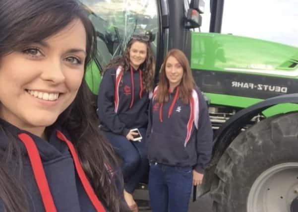 Left to right are: Lois Bingham, Rachael McMinn and Victoria McCabe pictured outside a Deutz Fahr from G A Allen Machinery the sponsors for this years treasure hunt and barbecue