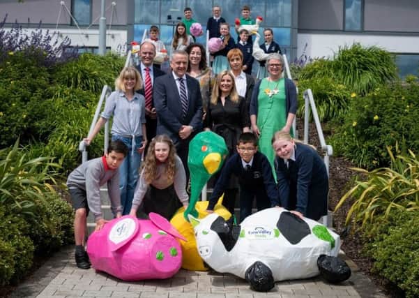 Trevor Lockhart, chief executive, Fane Valley, with Jenny Elliot, chief executive, Arts Care, Maeve McKervey, business manager, Arts & Business NI, and artists Clare McComish and Beth McComish and teachers and pupils from Moira Primary School and St Josephs, Crumlin