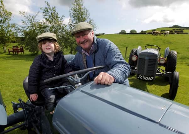 Robert Berry, Farm Manager at the Ulster Folk Museum in Cultra, shows budding farmer Matthew Gardner from Holywood some of the fleet of Ferguson tractors that will be on display at the museum at this yearâ¬"s Ferguson Heritage Tractor Day on Saturday, June 29.