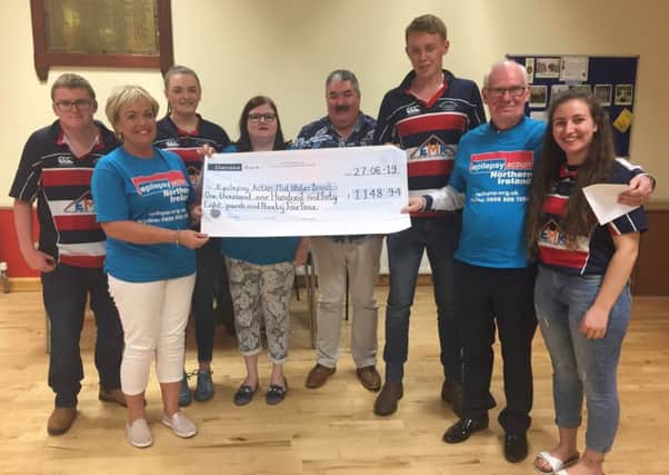 Club members Harry Wallace, Alison Davis, Steven Hogg and Claire Forsythe presenting Epilepsy Action members Glenda Henry, Claire Mulholland, David Archibald and Barry OHagan