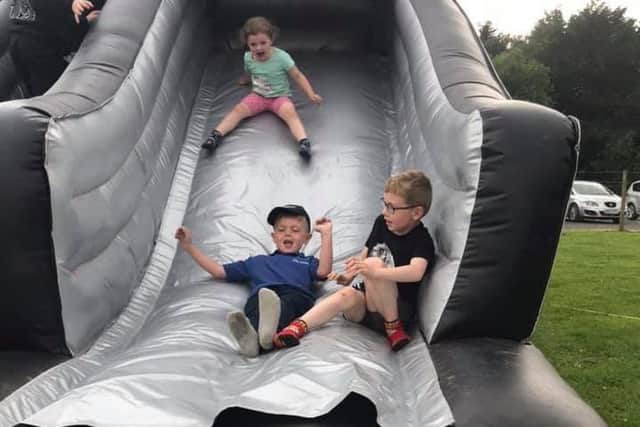 Olivia Killen, Isaac Robb and John Killen enjoying the bouncy castle