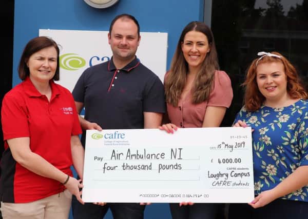 Student Representative Council President Laura Agnew and her deputy Conor McCartney along with SRC member Stephanie Cargill present cheque to Air Ambulance representative.