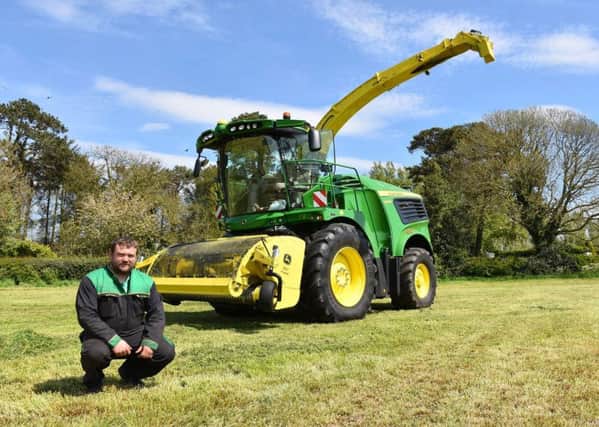 Michael Lagan with the new John Deere 9900i self-propelled forage harvester. PICTURE: Chris McCullough