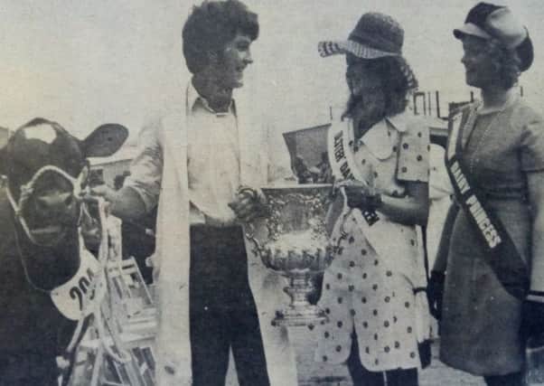 Pictured at Enniskillen are John Ligget, Tullyhue, Tandragee, who showed Tullyhue Fairy IV on behalf of his father, with Miss Yvonne Booth, Ulster Dairy Queen, and Miss Marion Cathcart