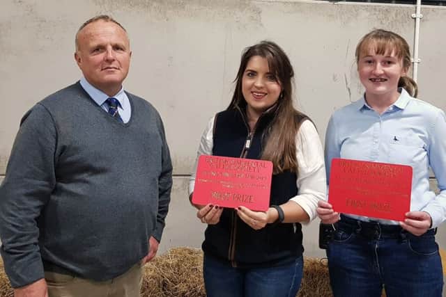 First place senior team members Alice Stubbs, Irvinestown, and Molly Bradley, Armagh, received their prize from British Simmental Cattle Society president Michael Barlow.