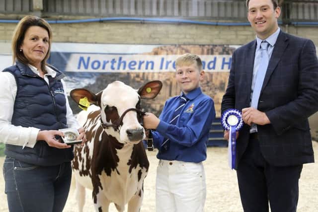 Reserve champion handler and winner of the intermediate Ayrshire showmanship class was Cameron Carson, Ballymena. Adding their congratulations are Alison Beattie, Farm Wardrobe, and judge Iwan Thomas. Picture: Jane Steel