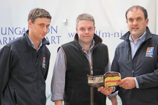 Looking over the catalogued entry for the September Dungannon Dairy Sale conducted by Taaffe Auctions are, sponsors Andrew West and Ian Cummins Irwins Feed; with judge Jonny Matthews, Lurgan. Picture: Julie Hazelton