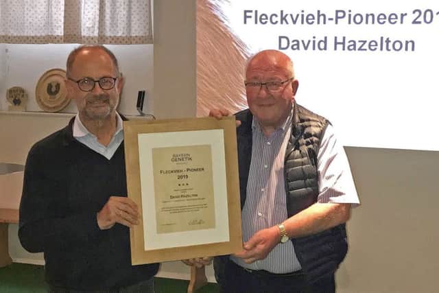 Dr Thomas Grupp, chief executive, Bayern Genetik, congratulates 2019 Fleckvieh Pioneer David Hazelton from Dungannon.