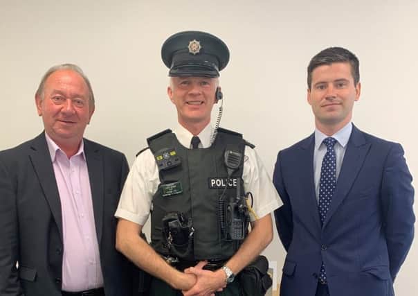 DUP MLAs William Irwin and Jonathan Buckley with Inspector Leslie badger.