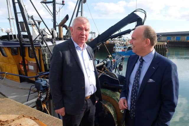 The Moderator, Dr William Henry with Sam Mawhinney, of Denholm Fishselling, at Portavogie's fishing port, County Down