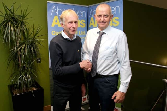 Hugh McCollum (Chairman AAQB) congratulates John Marshall, winner of the AA Dairy beef production herd competition at Aberdeen Angus Quality Beef Ltd AGM