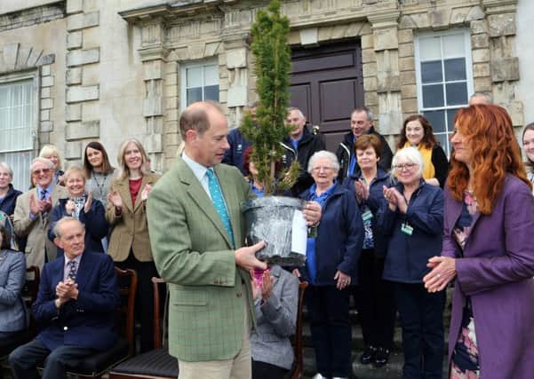 The Earl of Wessex is presented with an Irish Yew tree, to mark his visit to Florence Court, by Ms Heather McLachlan, Regional Director, National Trust.