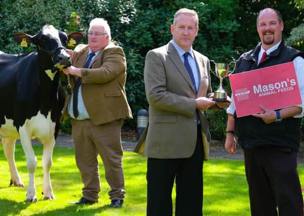 Michael Copeland, Mason's Animal Feeds, confirms the company's continued sponsorship of the October Dungannon Dairy Sale with auctioneer Michael Taaffe, and Holstein NI chairman Charlie Weir. Photograph: Columba O'Hare/ Newry.ie
