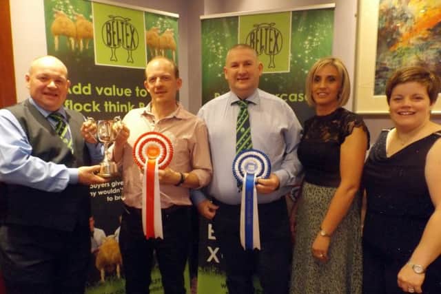 Matthew Burleigh's Matt's Flock was named Champion Flock, Large Flock. Receiving the award on his behalf from judge, John Barclay, is Andrew McCutcheon. Kenny and Janice Preston's Glenpark Flock was named Reserve Champion Flock in the Large Flock category. Also included is judge, Heather Barclay.