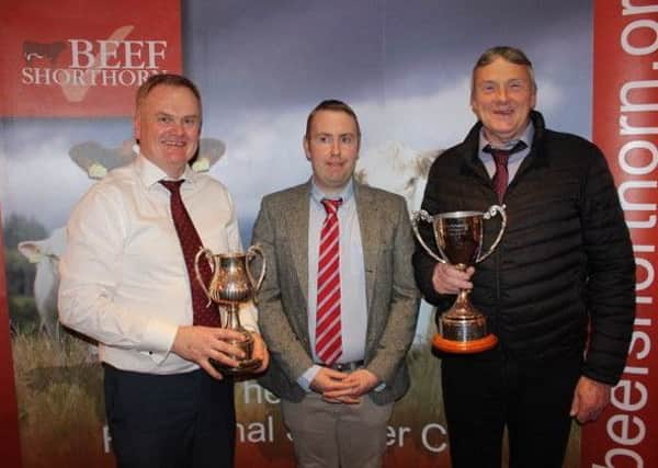 Richard Henning and Stephen Williamson picking up the overall champion and reserve awards from judge James Porter