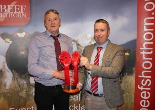 Stephen Williamson with the overall heifer group award with judge James Porter