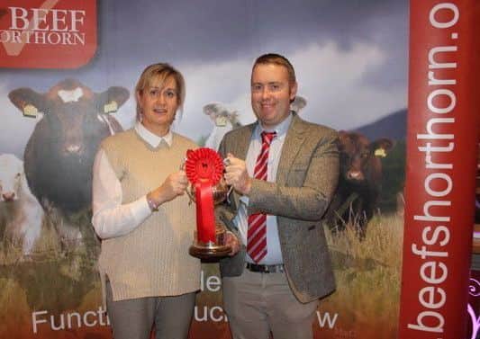 Carole Alexander representing Craigfaddock shorthorns winner of the overall young bull award  with judge James Porter