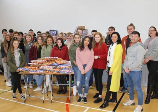 Students and staff from South Eastern Regional Colleges Downpatrick Campus donated over thirty-six hours volunteering to Cancer Fund for Childrens Daisy Lodge by wrapping selection boxes in preparation for a visit from Santa