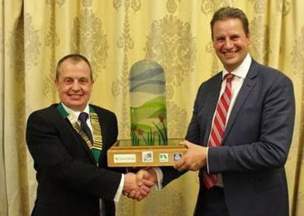 John Martin (right) and BGS president Richard Simpson at the presentation of the 2019 Grassland Farmer of the Year award