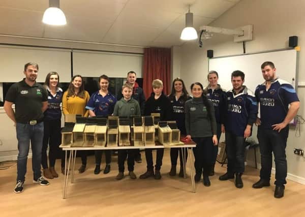 City of Derry YFC members hand over Red Squirrel feeders to Caroline from North West Red Squirrel Group
