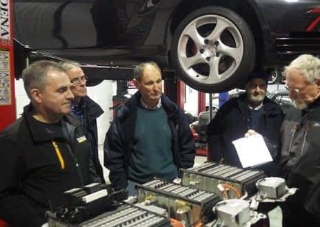 Having a discussion around a Toyota hybrid battery at McMillan specialist cars