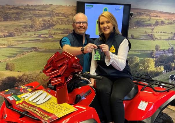 Countryside Services Bill and Lorraine show off the brand new Suzuki quad that will be won at Winter Fair.