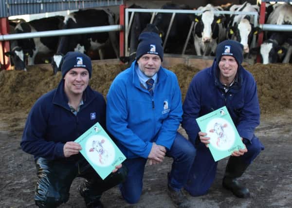 Ai Services' David Dunlop (centre) on farm earlier this week with Hillsborough dairy farmers Graham (left) and James Harrison