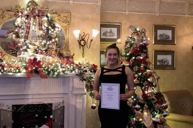 Abby Morrton with her certificates