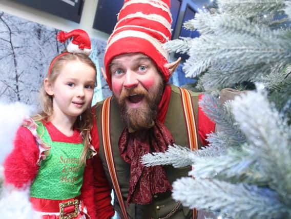Olivia Hamill with a elf at the North Coast Post Office. Picture: Kevin McAuley/McAuley Multimedia