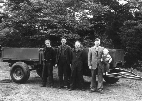 Pictured left to right  in 1947 at Crakemarsh are Bill Hirst MBE, employee number one Arthur Harrison, employee number two Bert Holmes and Company Founder Joseph Cyril Bamford with a young Lord Bamford in his arms.