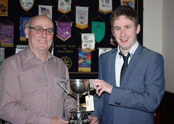 Highest prize-winner Bertie Blair (l) collects the Harper Cup from Robert Turkington