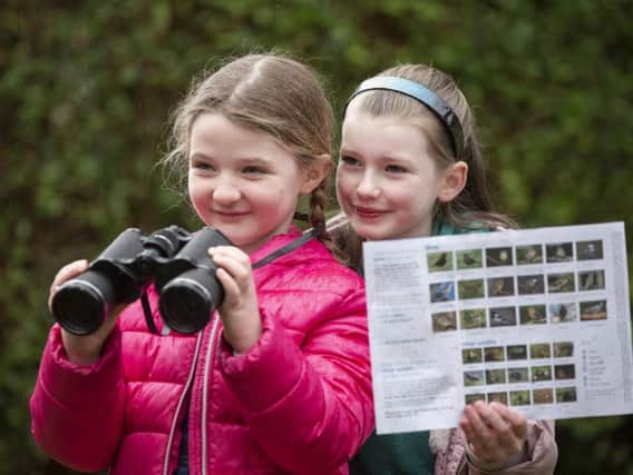Friends Sophia and Sophie, pictured in Belfast, getting ready to take part in the RSPB Big Garden Birdwatch. Picture: Mark McCormick