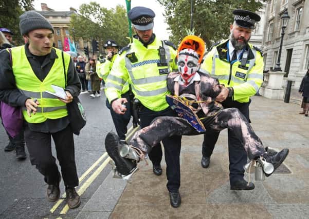 PA REVIEW OF THE YEAR 2019 

File photo dated 07/10/19 of police holding a protester during an Extinction Rebellion (XR) demonstration in Westminster, London. PA Photo. Issue date: Sunday December 15, 2019. See PA story XMAS 2019. Photo credit should read: Yui Mok/PA Wire