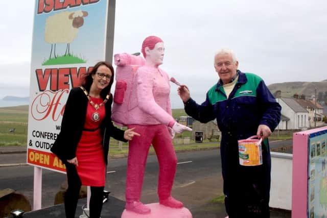 Moyle District Council Chairperson, Cllr Cara McShane, pictured with her father, Seamus, at the Sheep Island hostel in Ballintoy, where Seamus has painted his Harry Ferguson tractor pink and the back packer has gone pink as well.... has said that preparations are well underway across the North Coast in preparation for the Giro dâ¬"Italia cycling race. PICTURE KEVIN MCAULEY PHOTOGRAPHY MULTIMEDIA
