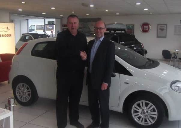 Rob pictured receiving the keys of the new car won in 2015 from Eamon Kelly, NFC
