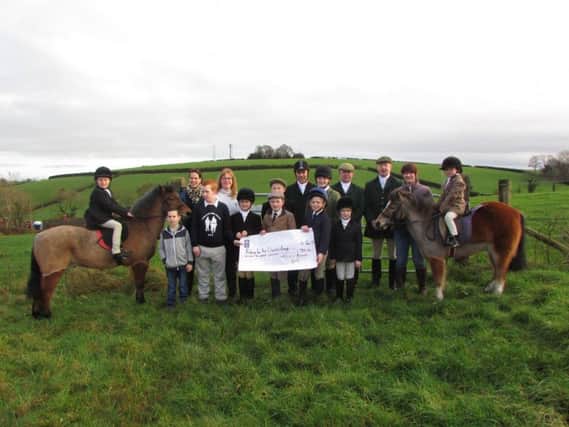 Tynan and Armagh Hunt Officials and Junior Members presenting cheque to Joanne Morton, Riding for the Disabled, Armagh Branch.