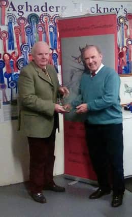 Norman Brown presenting the Alex Presho Memorial Trophy to Joe Quigg Club Chairman.