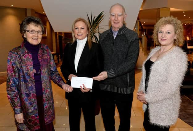 Joan Cunningham, organiser of Saintfield Christmas Charity Ride, presents a cheque to Ian and Phyllis Hasson (Rock Ministries N.I. Trust). Also included is Lorraine Johnston.