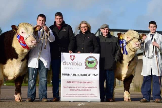 Judge Des kelly with the champion and reserve champion and sponsors Dunbia,