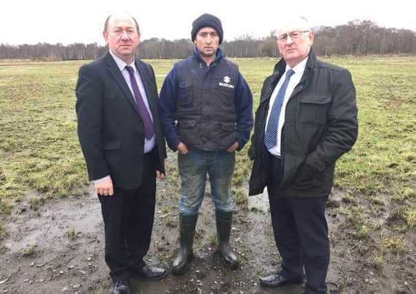 DUP MLAs William Irwin and Sydney Ander with farmer Matthew Harrison
