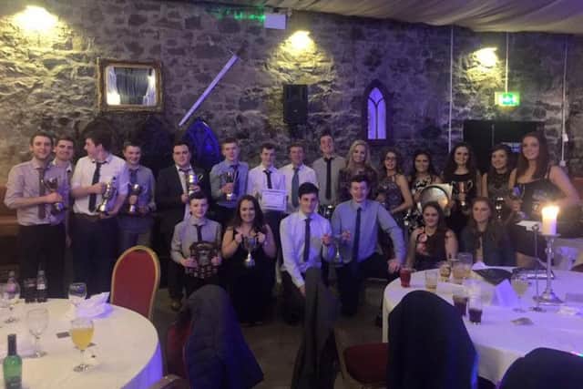 Lisnamurrican YFC prizewinners who attended the 75th club dinner, showing off their silverware