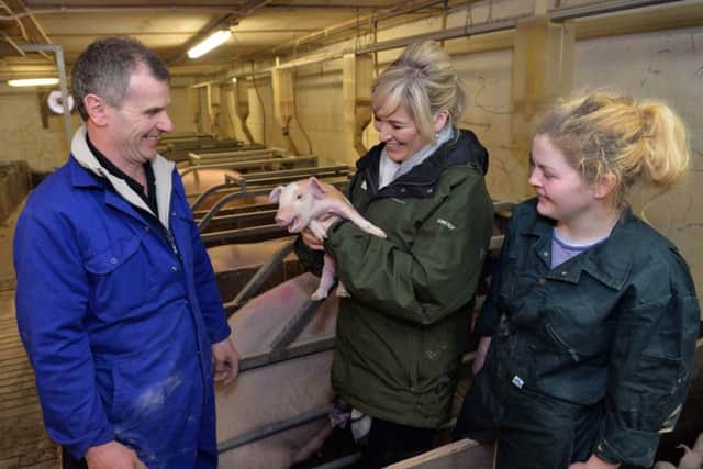 Pig farmer Gary Anderson, DARD Minister Michelle O'Neill and employee Michaela Quinn from Ardboe.