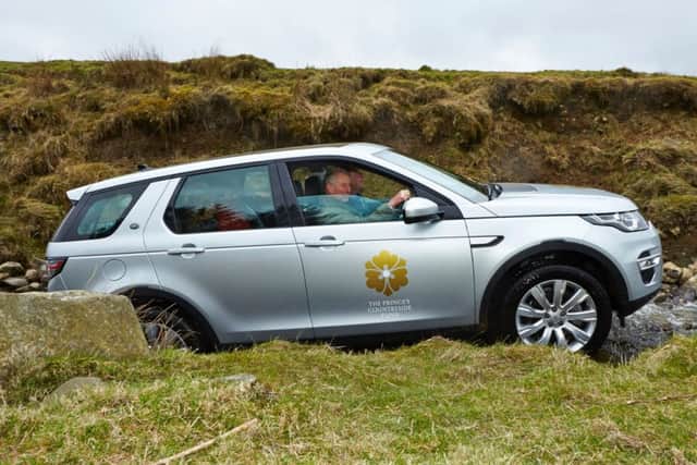 HRH Prince of Wales a driving Land Rover Discovery Sport through a beck at Rookin House, Cumbria as part of the Land Rover Princes Countryside Fund Bursary launch