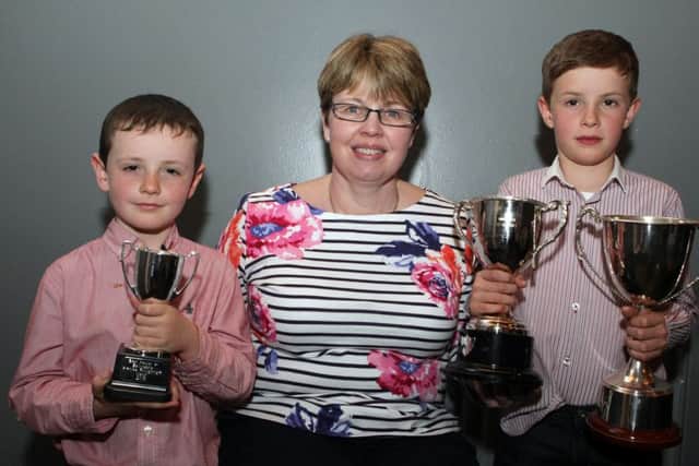 Gillian Wilkinson presents awards to Conall and Daniel Lynn at the Ballycastle & District Horse Ploughing Society's annual dinner at Hunter's Bar, Ballyvoy on Friday night.