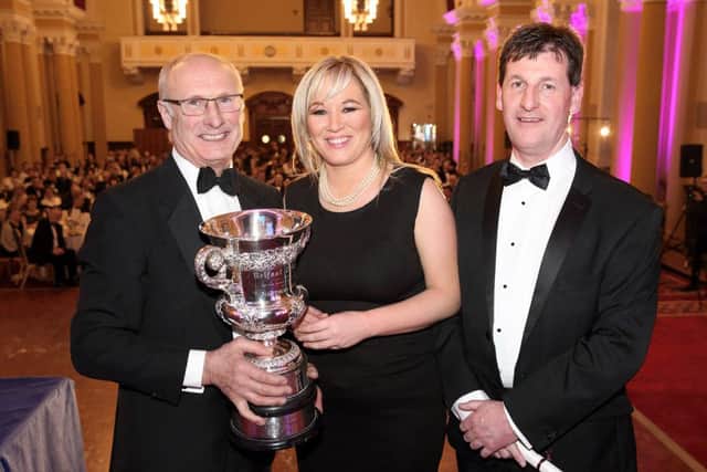 Clarke Black was awarded the prestigious Belfast Telegraph Cup this year for outstanding agricultural achievement. Pictured accepting the trophy on his behalf is Cyril Miller, UFU County Londonderry Chairman, with Minister ONeill and Wesley Aston, UFU Chief Executive.