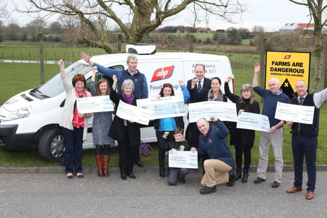 Pictured at the cheque handover to mark ABP, which has sites in Newry and Lurgan, raising more than £67,000 for local charities, are (back row l-r) Seamus Kenny from ABP and Roger Sheahan from ABP with (middle row l-r) Sheila King and Siobhan Murphy from Head Injury Support Newry, Eileen Wright from Southern Area Hospice, Lisa Mallon from Alzheimer's Society, Fiona McCabe from Brain Injury Matters, Pattie and Paul McElroy from SMART NI and Elwyn Pugh from ABP and (front row l-r) Finbar Mallon from Alzheimer's Society with Philip Simpson from ABP.