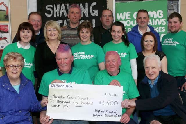 Jim Beggs, Yard Supervisor Ballymena Mart with staff and customers who raised an impressive Â£6500 for Macmillan Cancer Support recently when they braved the Shaving Station set up at the Mart for a cut, colour and style!