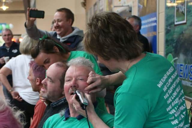 Jim Beggs, Yard Supervisor, Ballymena Mart, getting a cut, colour and style as part of a fundraising event for Macmillan Cancer