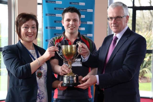Best Under 21 Ulster Young Farmer of the Year, Richard Beattie, Finvoy YFC pictured with John Henning from sponsor Danske Bank and YFCU President Roberta Simmons.